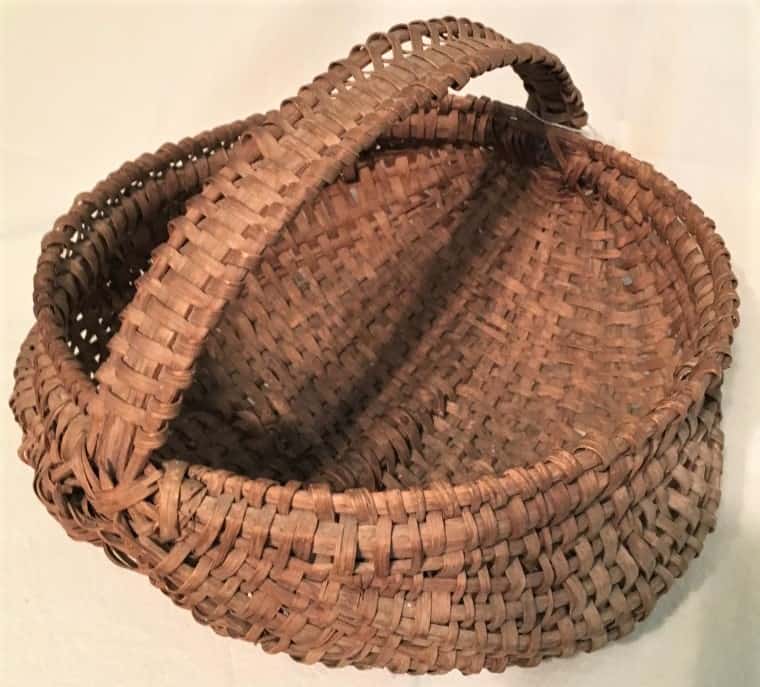 Rib basket featuring a handle with ribs on either side and woven design.