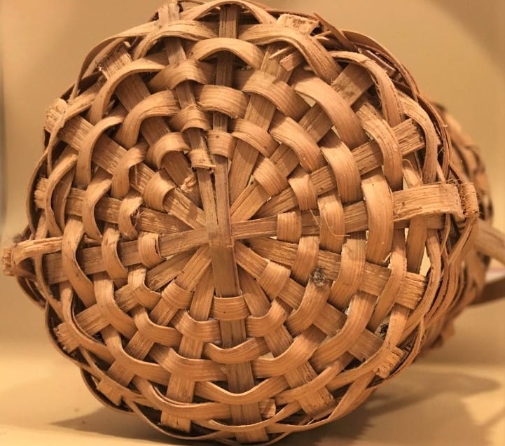 Base of flower basket with stake split to allow continuous weaving.