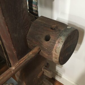 Wooden rachet wheel adjusted by inserting pole in different holes.