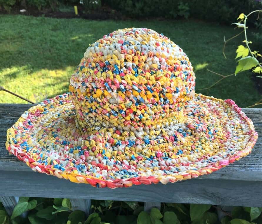 Colorful hat crocheted from strips of plastic bags.