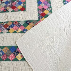 Quilting patterns show clearly on the white cotton backing of this quilt.