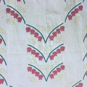 Clusters of applique flowers accent the center and edges of this quilt.