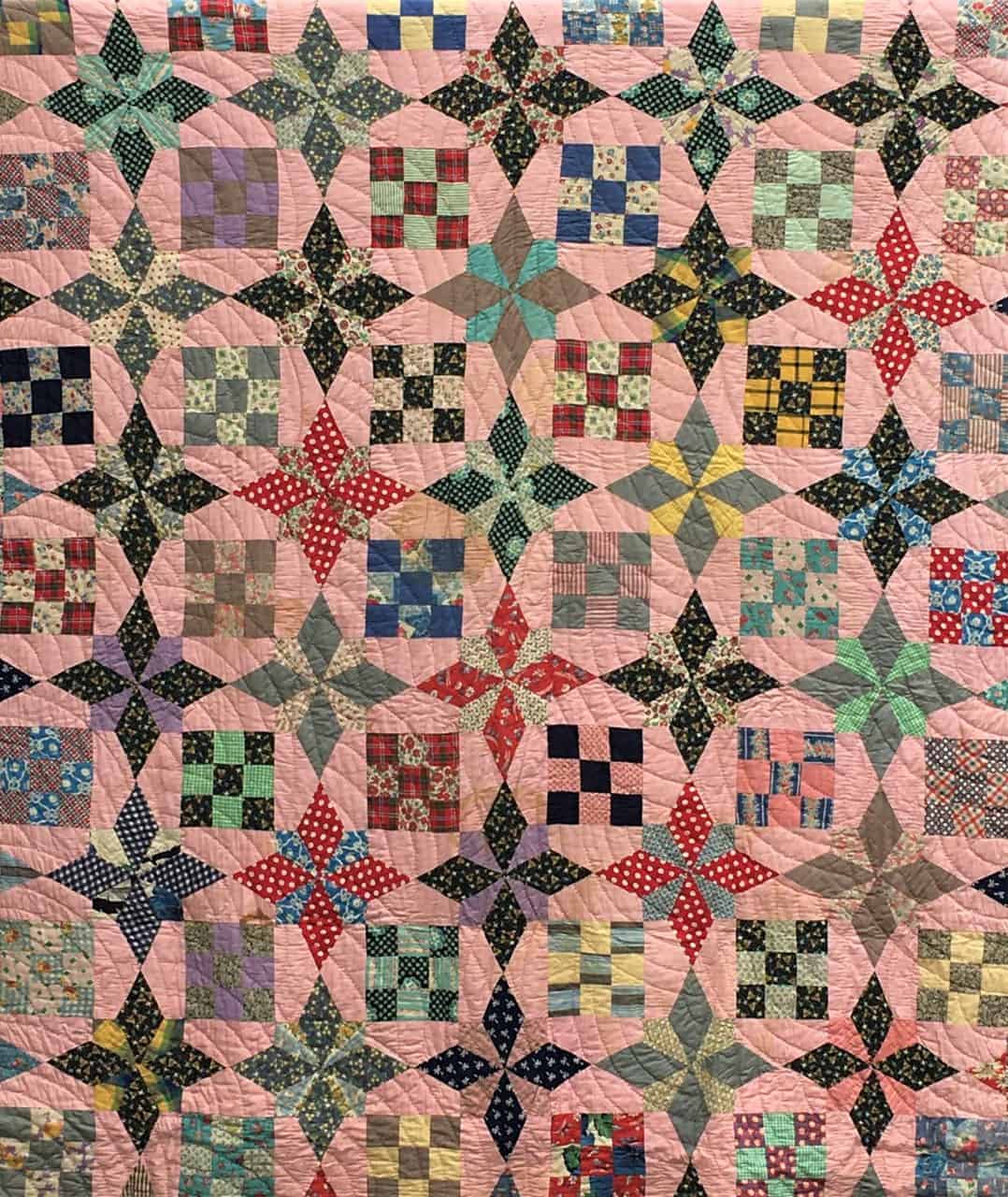 A combination of Nine Patch and star patterns create this quilt.
