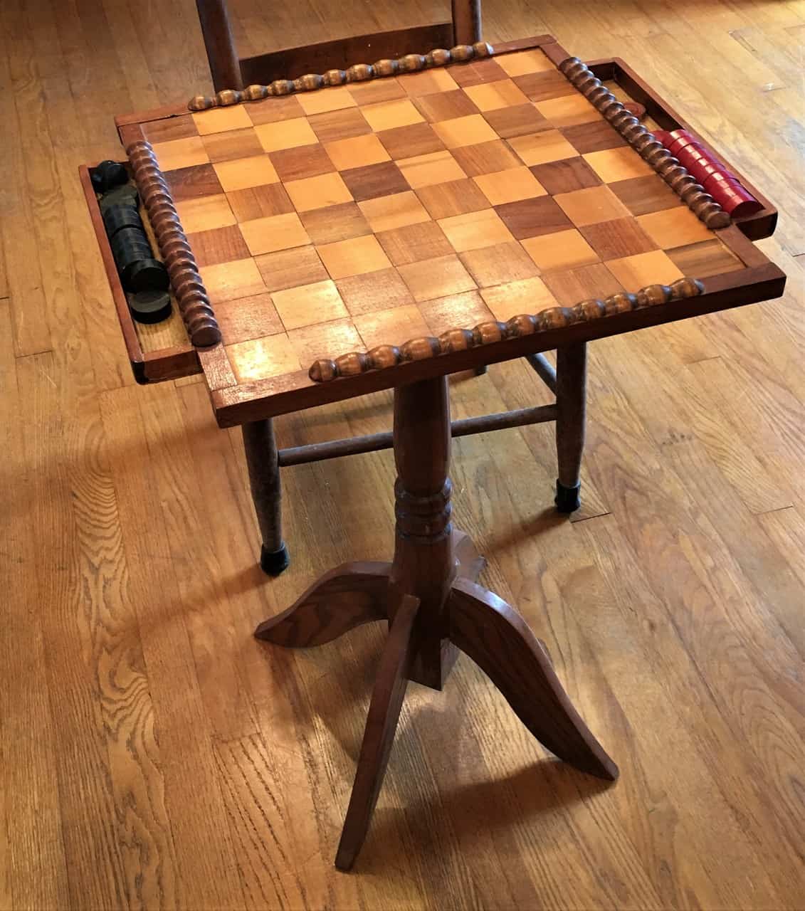 Checkerboard table with built-in trays to hold the checkers.