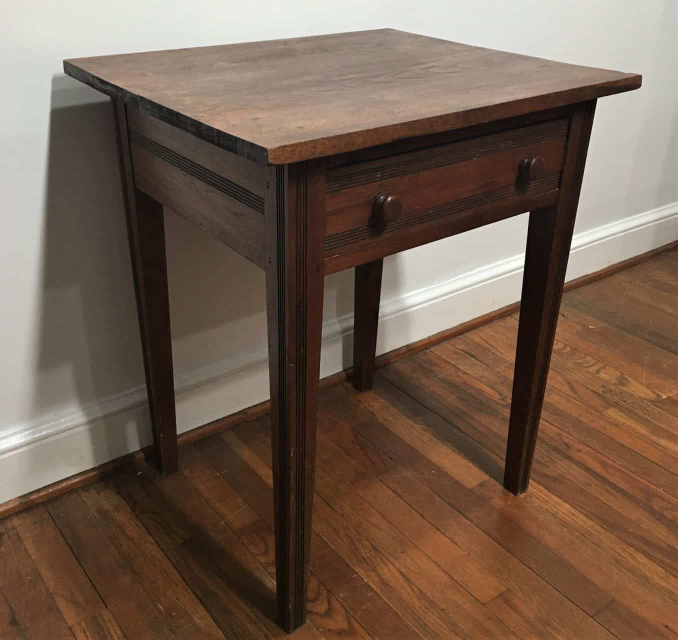 Cherry and walnut side table with a drawer.