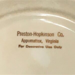 Stamped manufacturer name for commemorative plates.